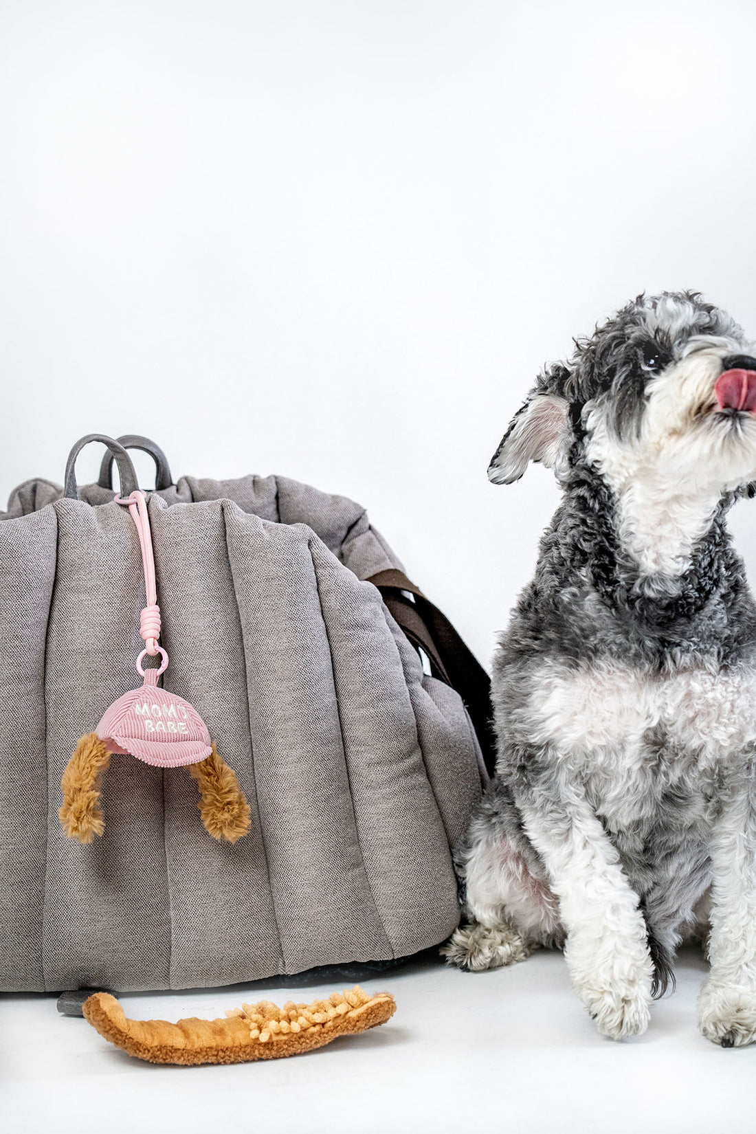 Pink CLIK compact travel dog enrichment toy with pink clip and layered treat pocket designed for portable sniffing play