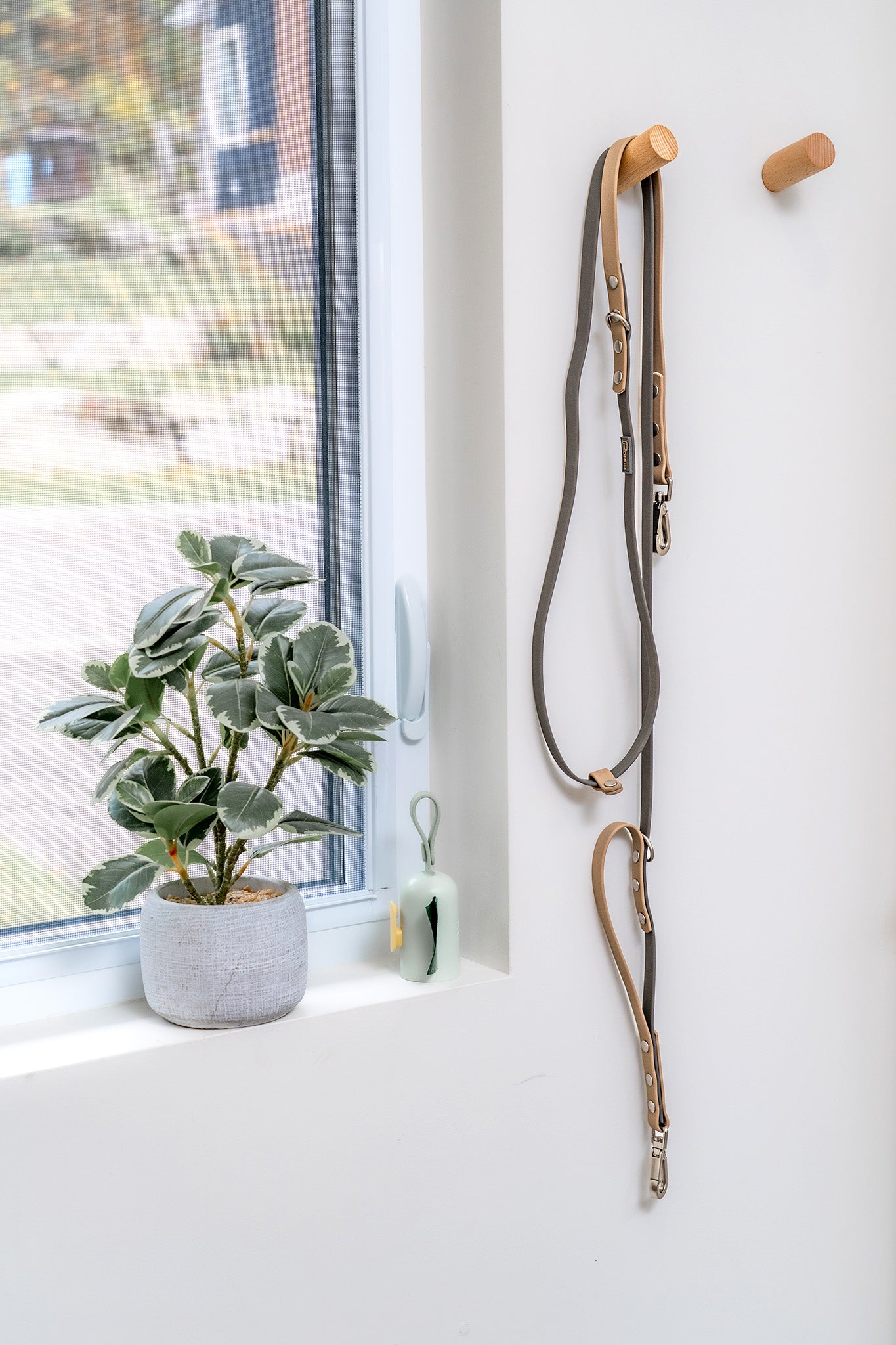 DUO Premium waterproof dog leash hanging on wall hook next to the door