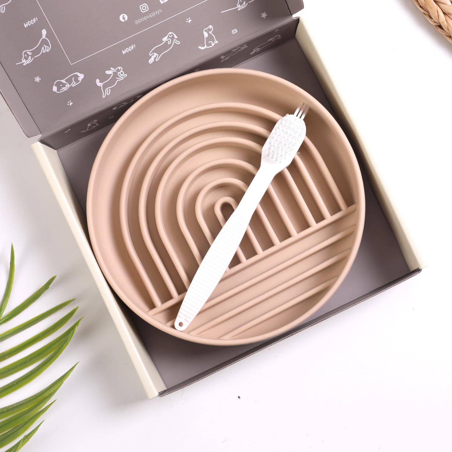 Tan silicone slow feeder dog bowl with cleaning brush in branded gift box